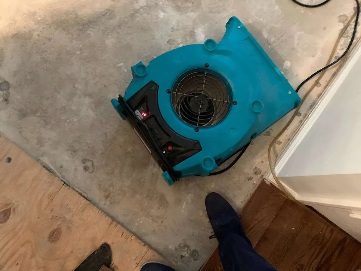 Air mover drying subfloor during Leak Detection & Repair in Mustang